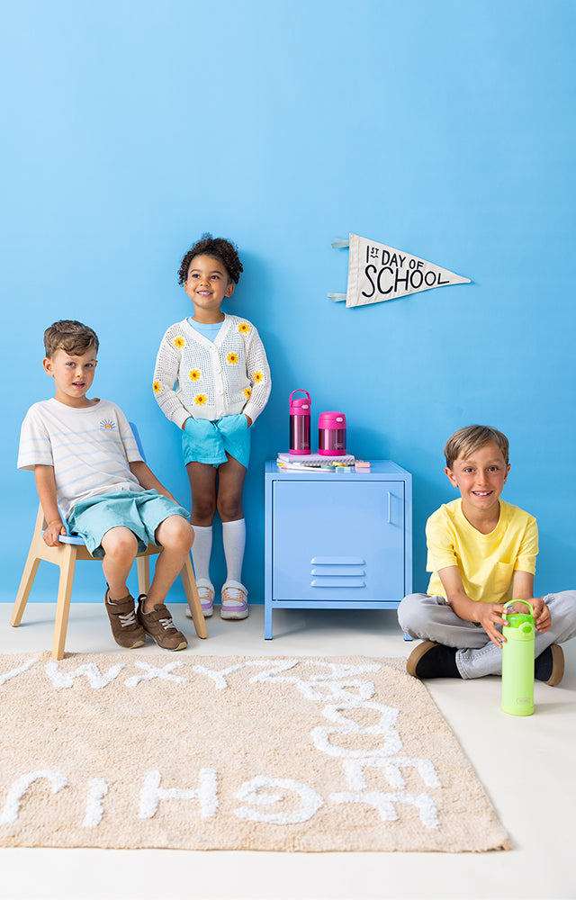Three children with Thermos FUNtainer products against a blue background