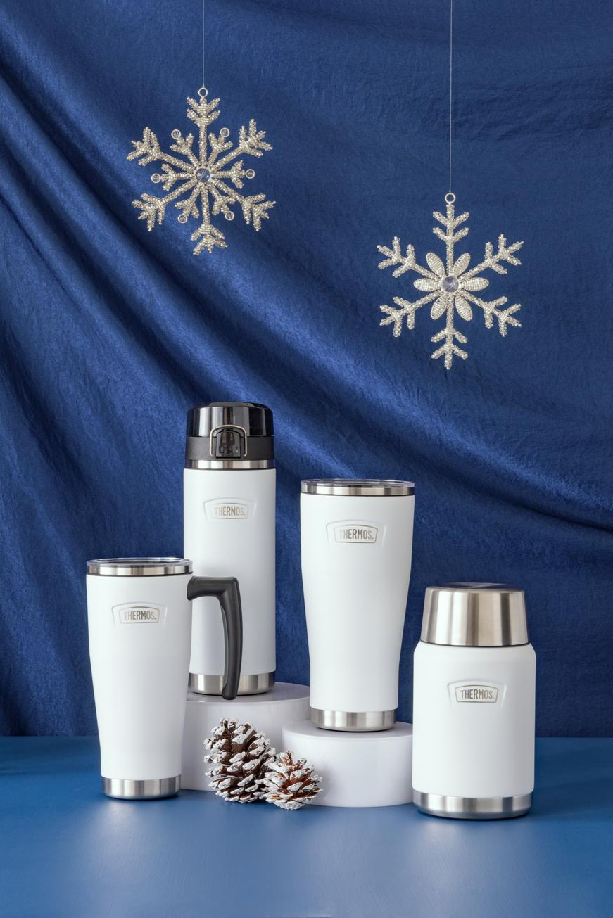 Set of white thermos bottles with silver lids on a blue background with snowflake decorations.