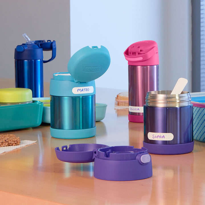 Funtainer food jars and water bottles and kids' lunch boxes on a cafeteria lunch table.